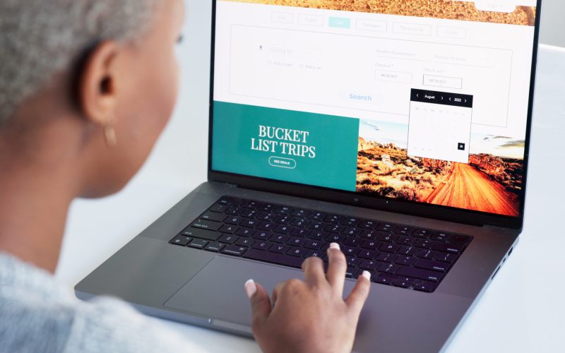 Laptop, hand and bucket list with a woman on the search online for an idea for a trip, holiday or v.