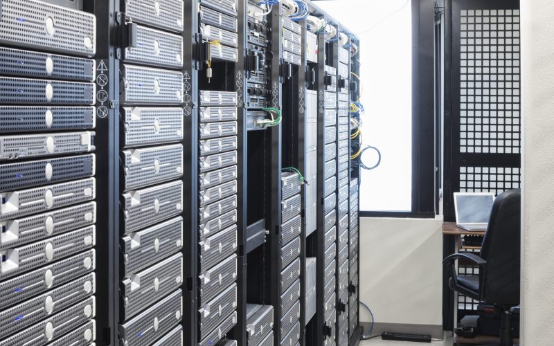 Servers in an aisle of racks in a computer server farm.